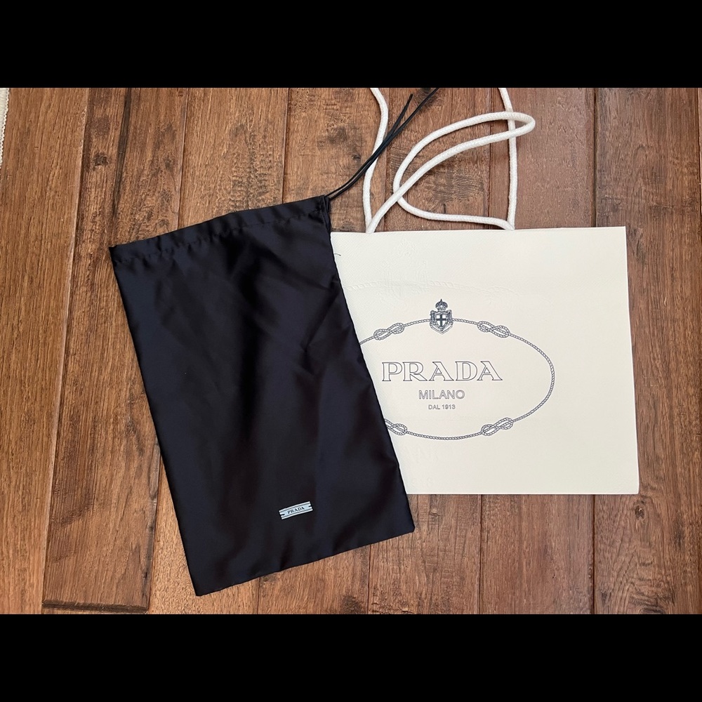 Prada shopping bag and navy dust cover.